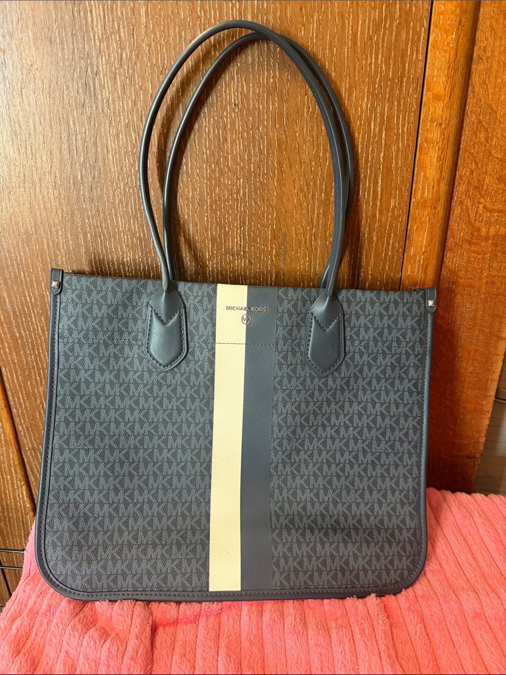 Michael Kors Navy blue Tote with White Center Stripe appears cream in the photo.